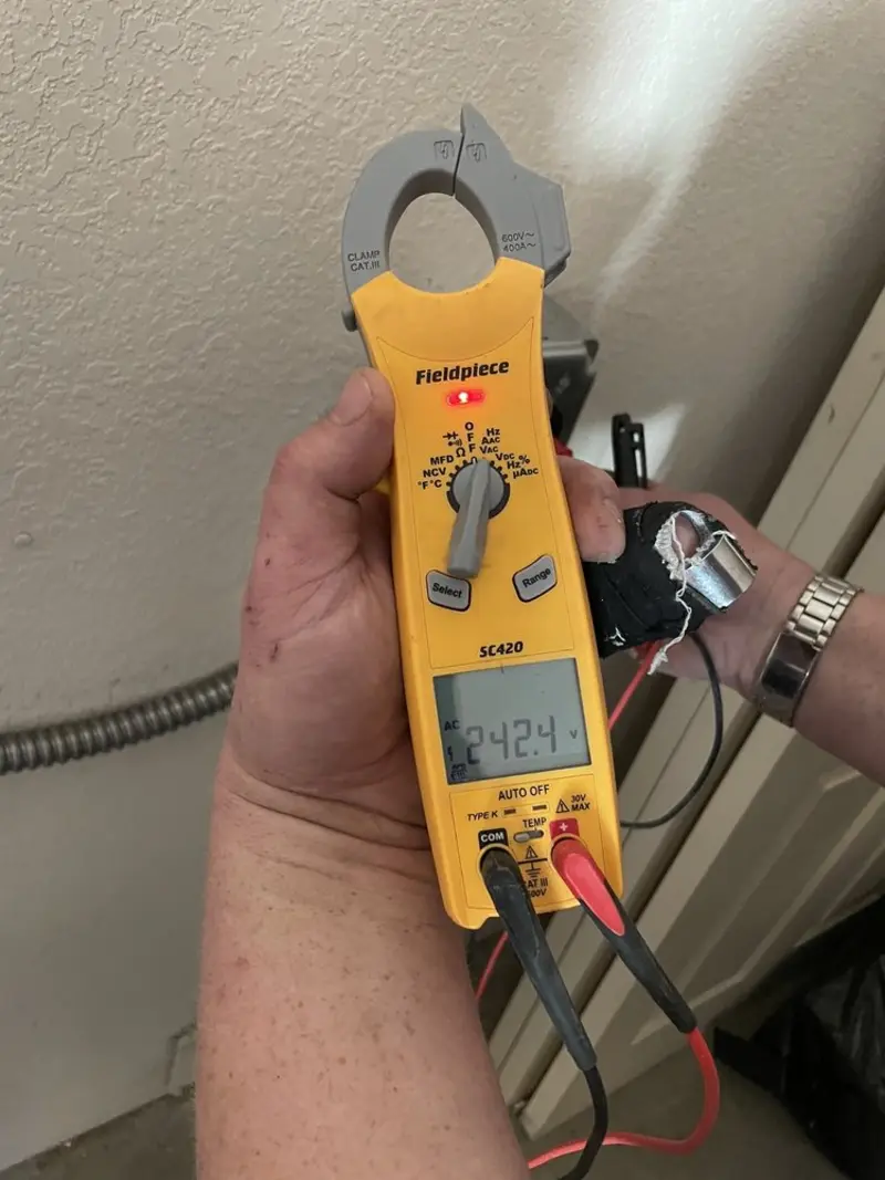 Voltage testing with clamp meter during Recessed Lighting Installation in Louisville